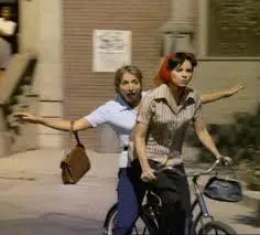 Penny Marshall and Cindy Williams, riding a bicycle, in a scene shot solely for the "Laverne & Shirley" theme song.