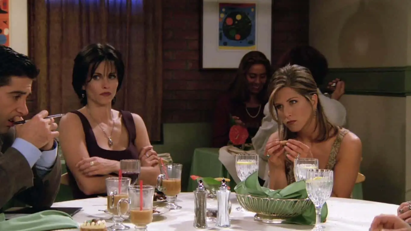 Rachel looks irked in this scene on "Friends" because Ross doesn't seem to realize how broke some of the friends are.